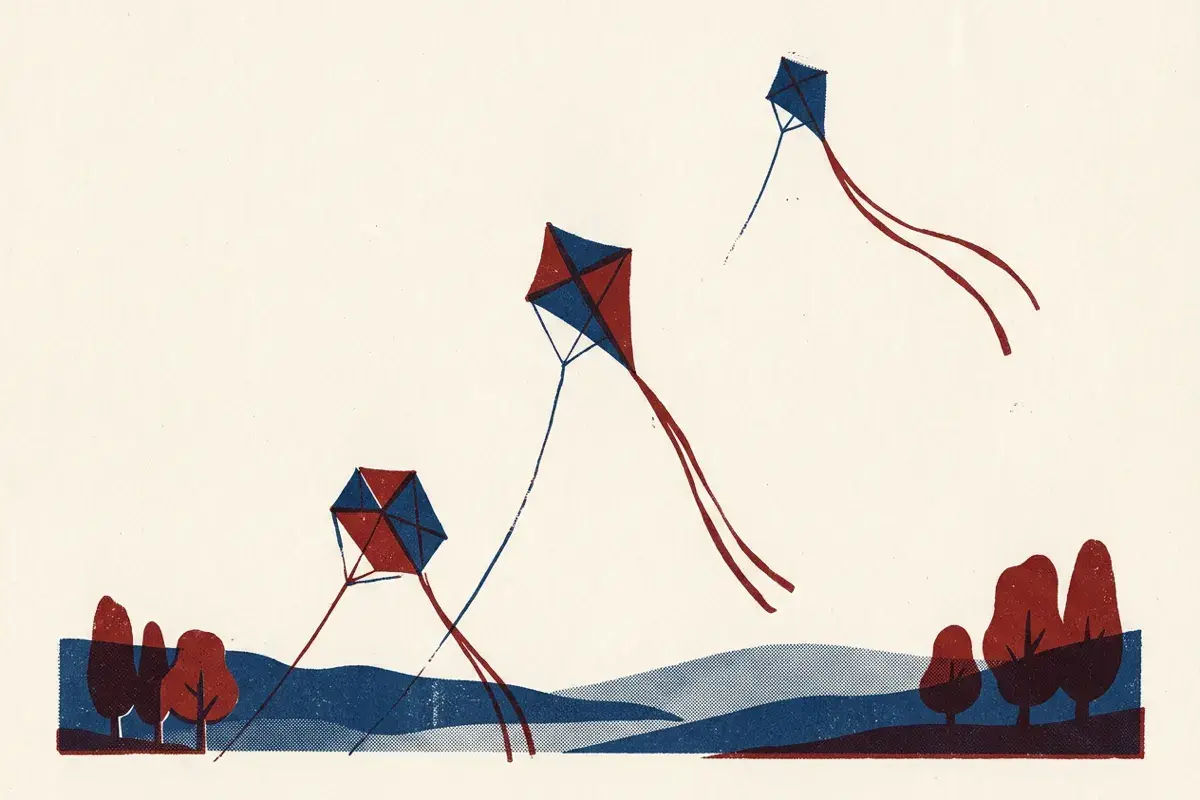 Three kites flying at increasing heights, the highest with a long tail.