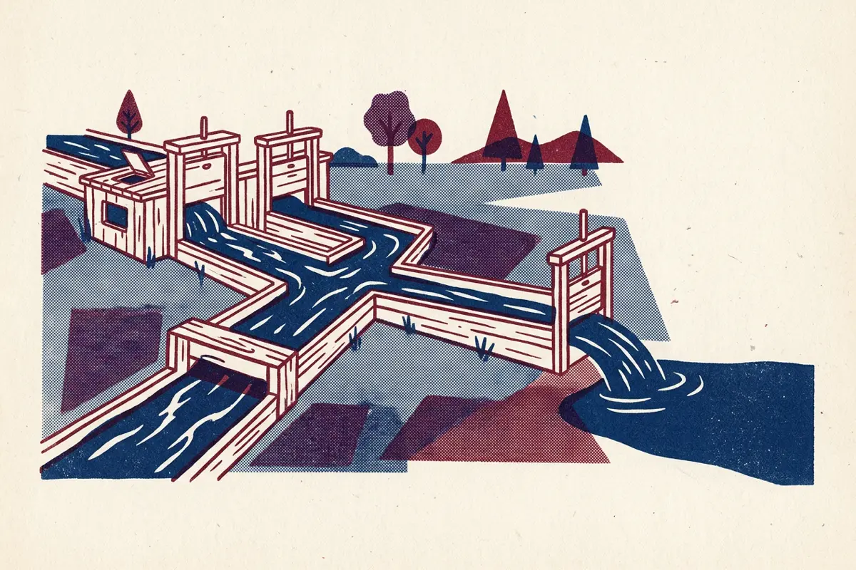 A stream flowing through wooden sluice gates and channels across a meadow.