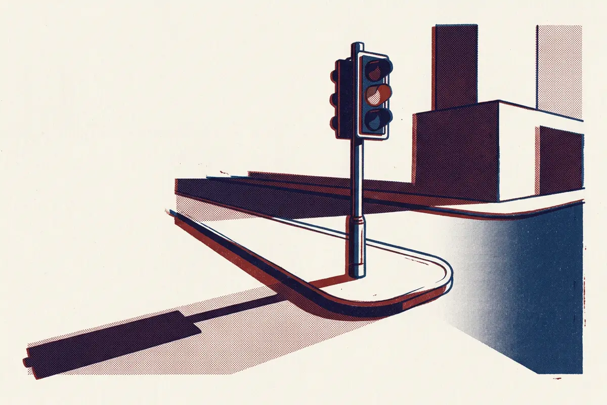 A traffic light on an empty street corner with only the amber light lit.