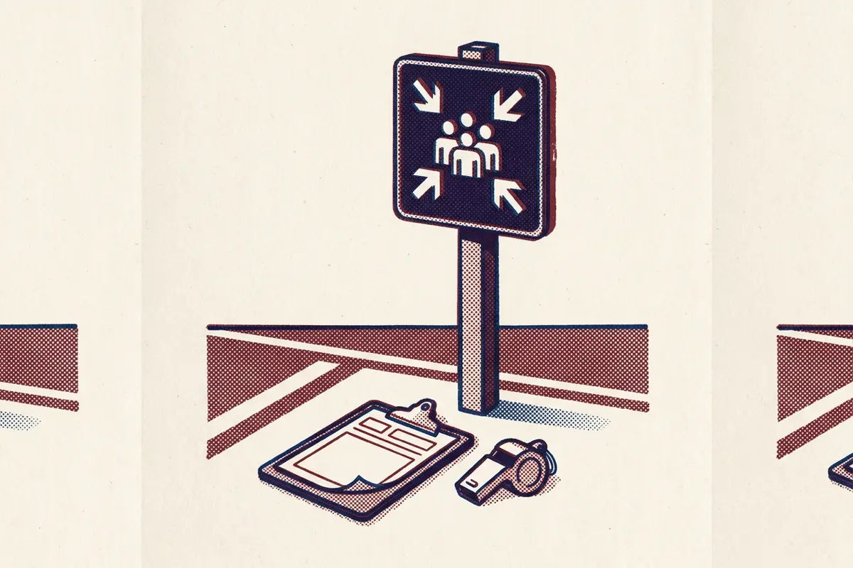 A blank assembly point post in an empty car park with a clipboard and whistle at its base.